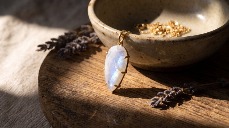 Moonstone necklace on wooden bowl with lavender